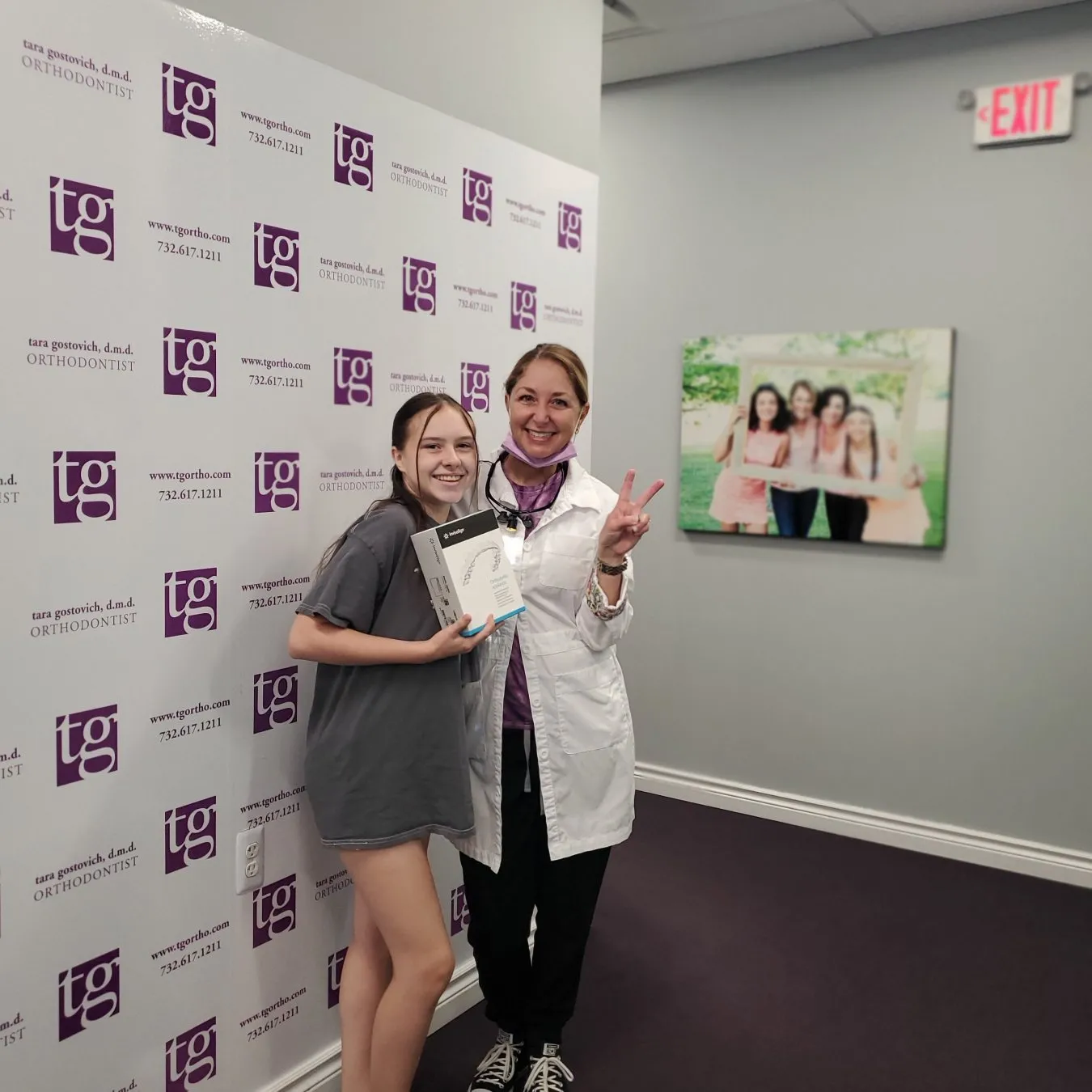 Dr. Tara Gostovich posing with a smiling teen patient in her Marlboro office, a short drive for families who want an orthodontist in Holmdel, NJ