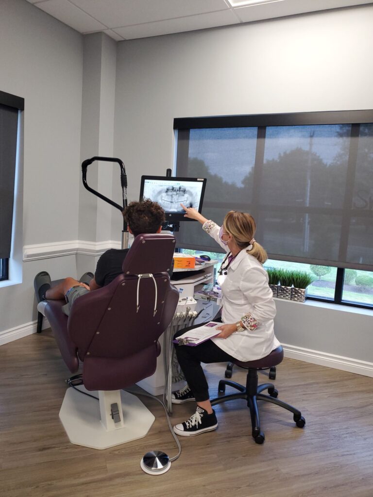 Dr. Gostovich reviewing a scan on screen, showing what to expect at an orthodontic consultation