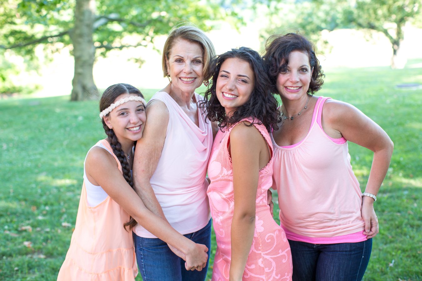 Four women smiling together, showing the discreet results of Invisalign for adults