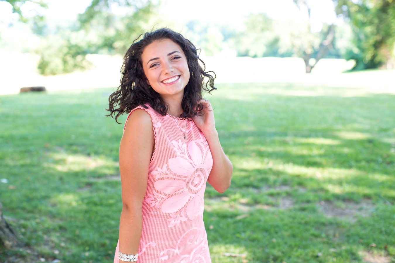 Teenager smiling confidently while wearing clear aligners from Invisalign Teen